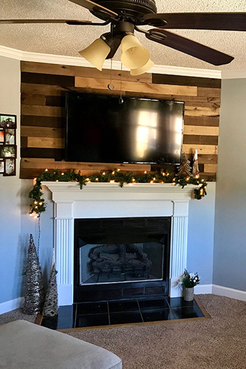 A beautiful wood planked wall using Weaber Wethered Boards that add a simple rustic feel to our living room