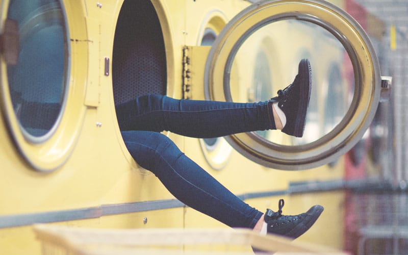 Am I A Homemaker | woman's feet hanging out of washing machine