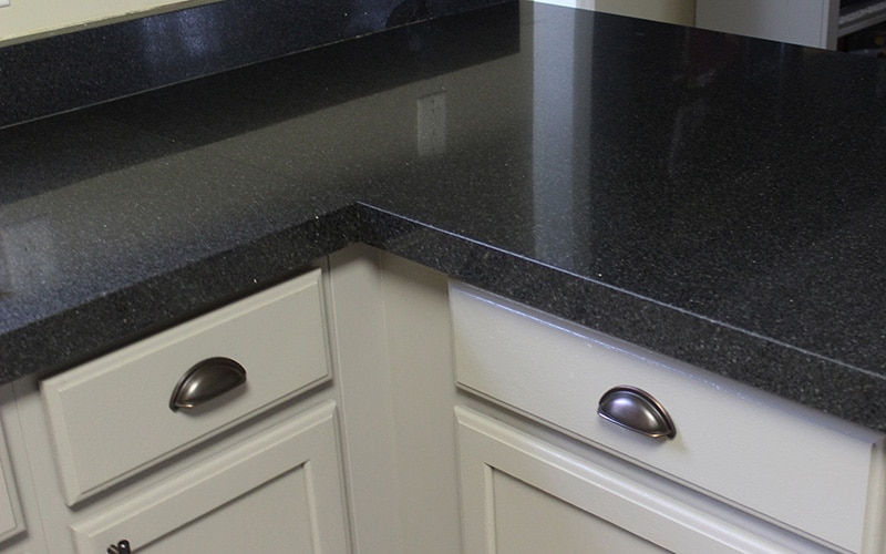 black granite countertops with gray kitchen cabinets