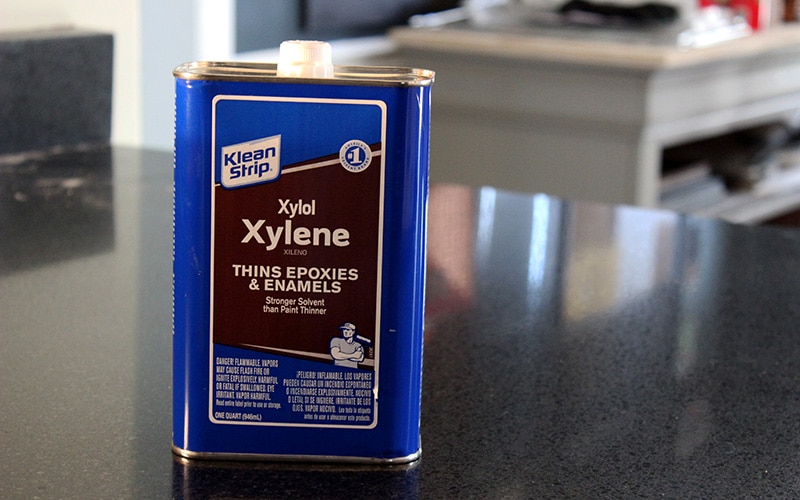 xylene container on black granite countertop