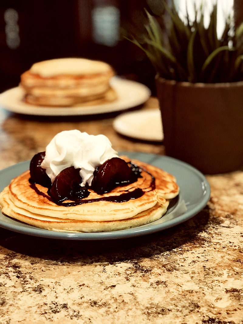 pancakes topped with fruit and whipped cream