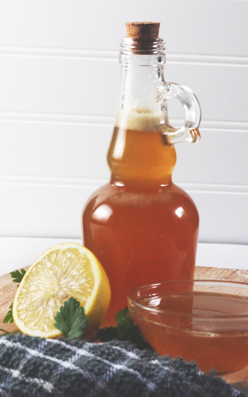 honey garlic dipping sauce with lemons on wooden cutting board