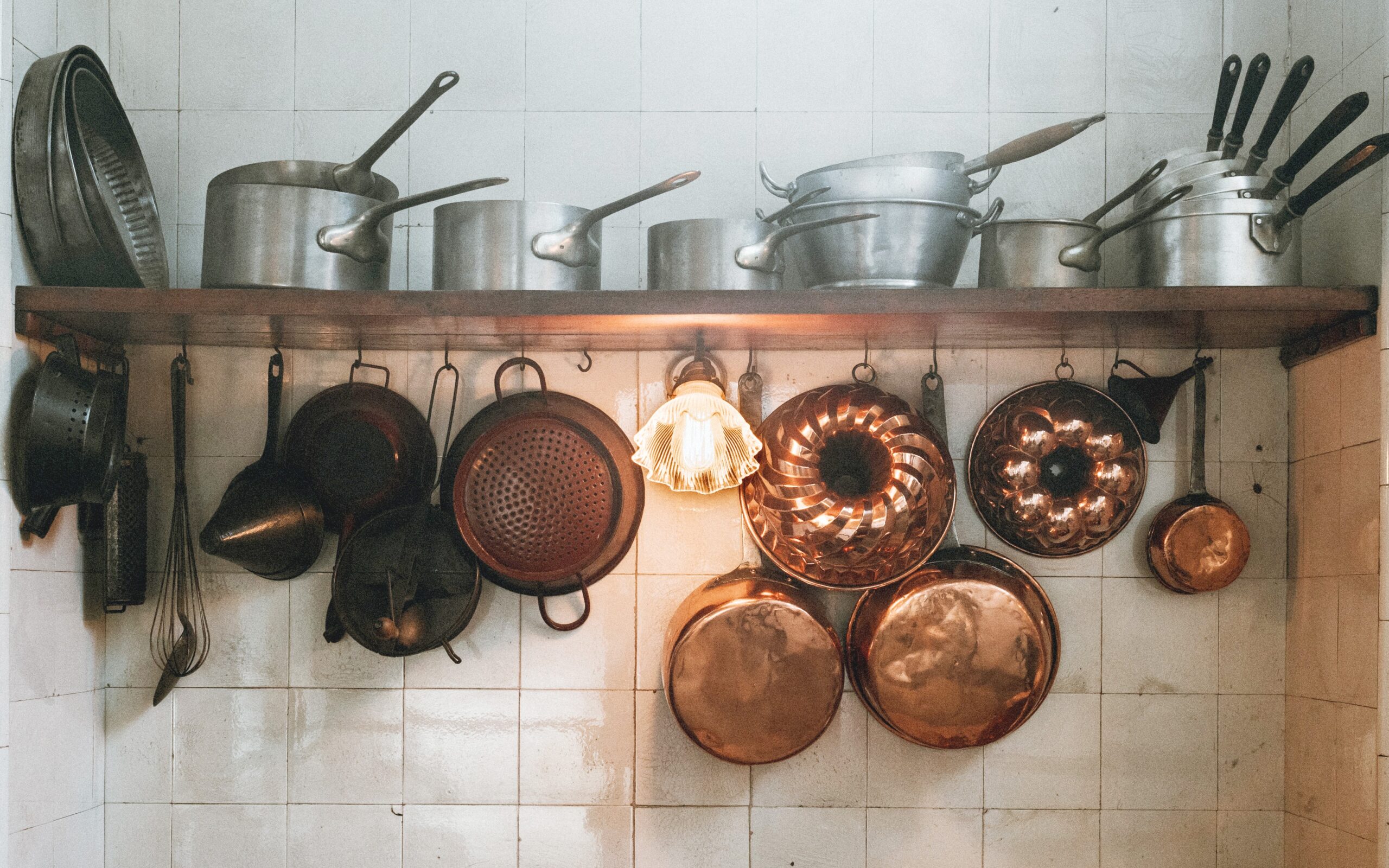 pots and pans hanging on kitchen wall