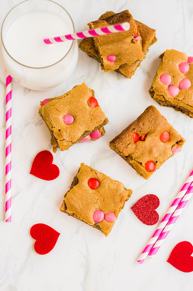 m&m blondies cutting into squares and served with milk