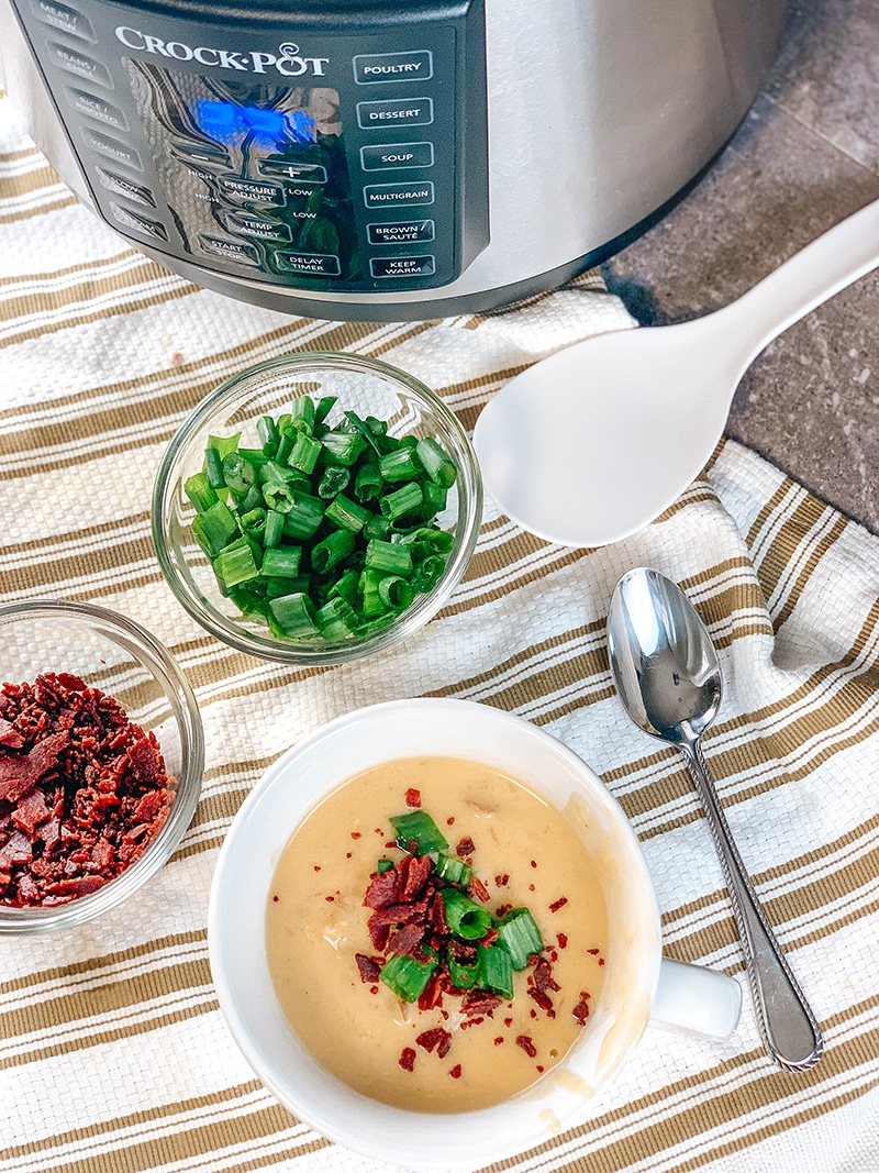 instant pot loaded baked potato soup with scallions and turkey bacon bits