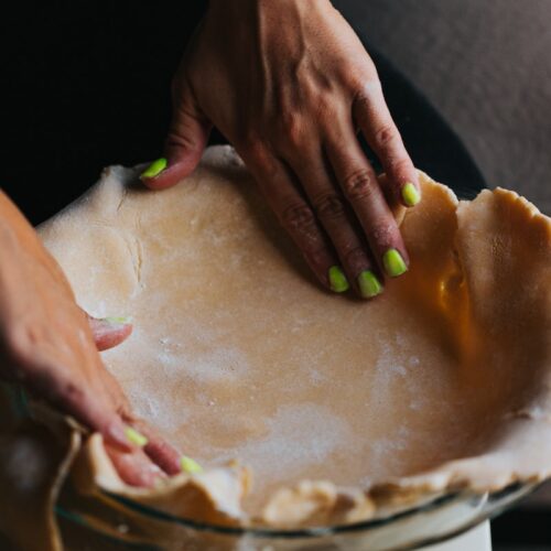 person holding brown round cake