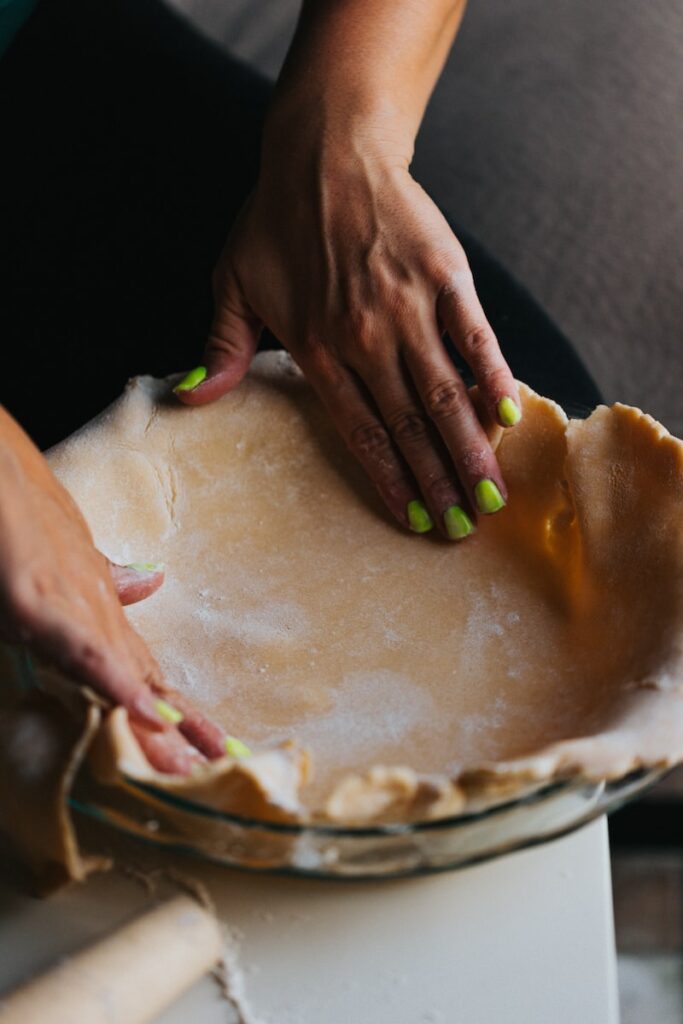 person forming pie crust