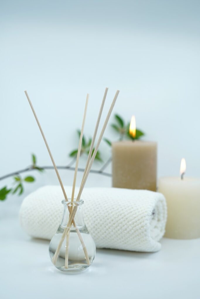 white pillar candle on holder spa experience