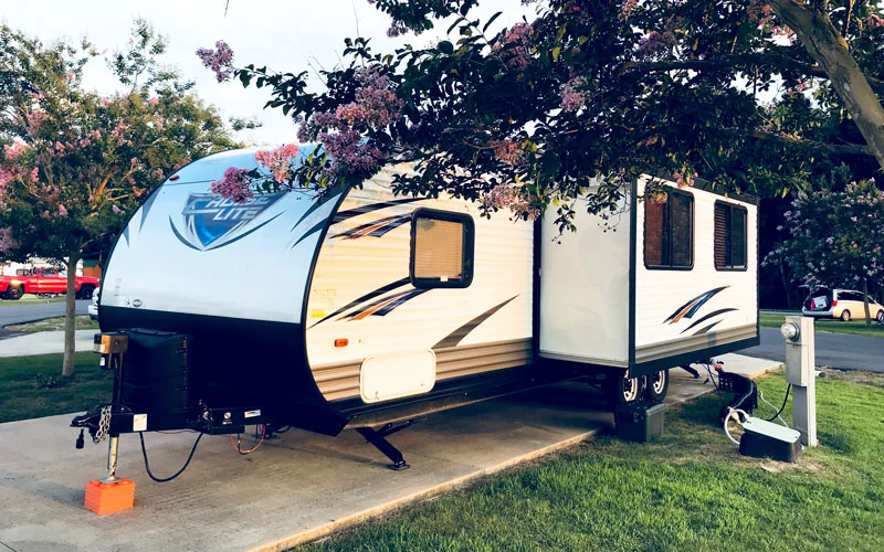 travel trailer parked at campsite
