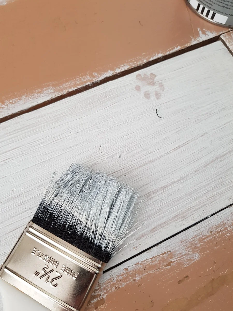 | Kenya Rae White Paint on Wooden Surface